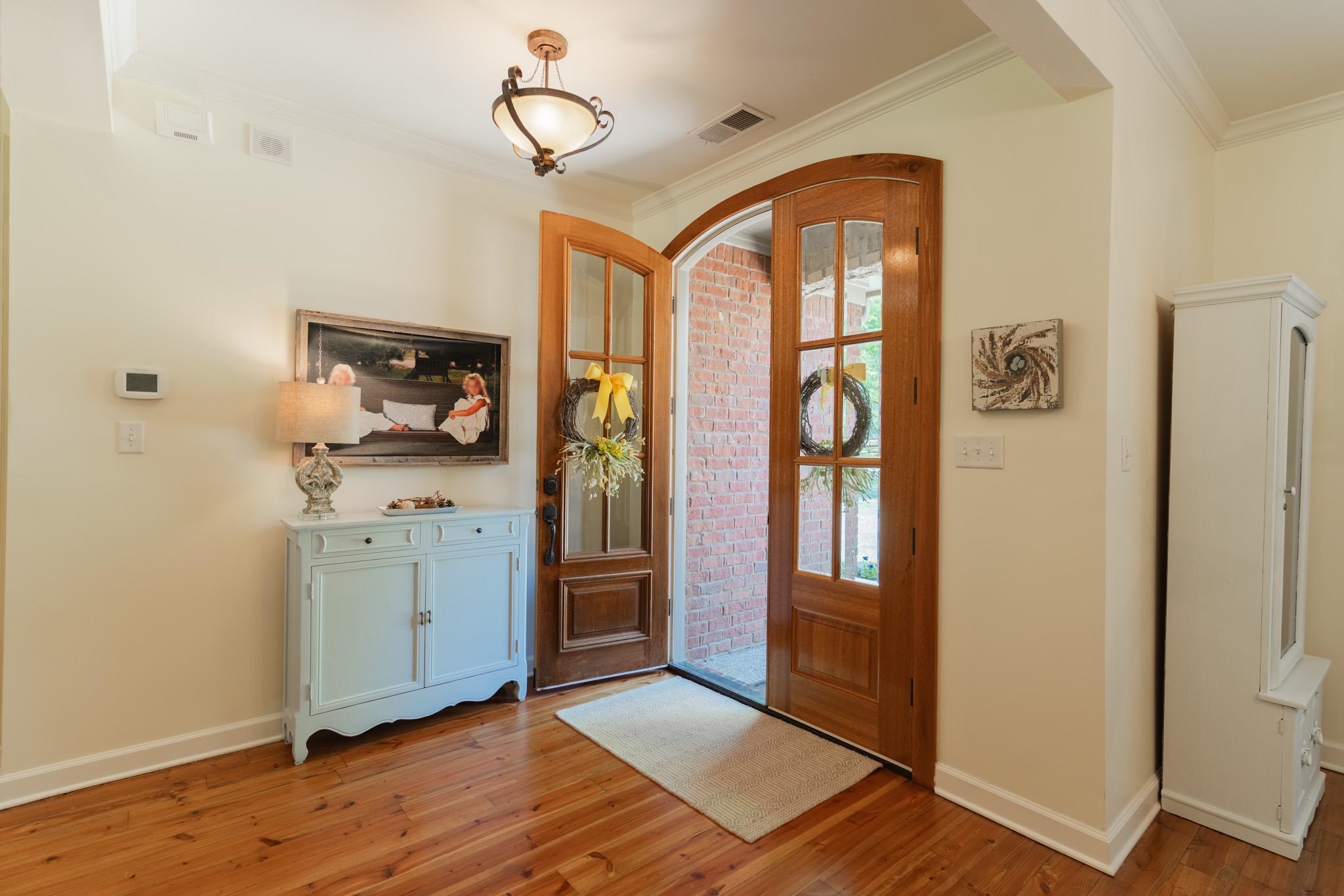Beautiful double doors open to a spacious entry.