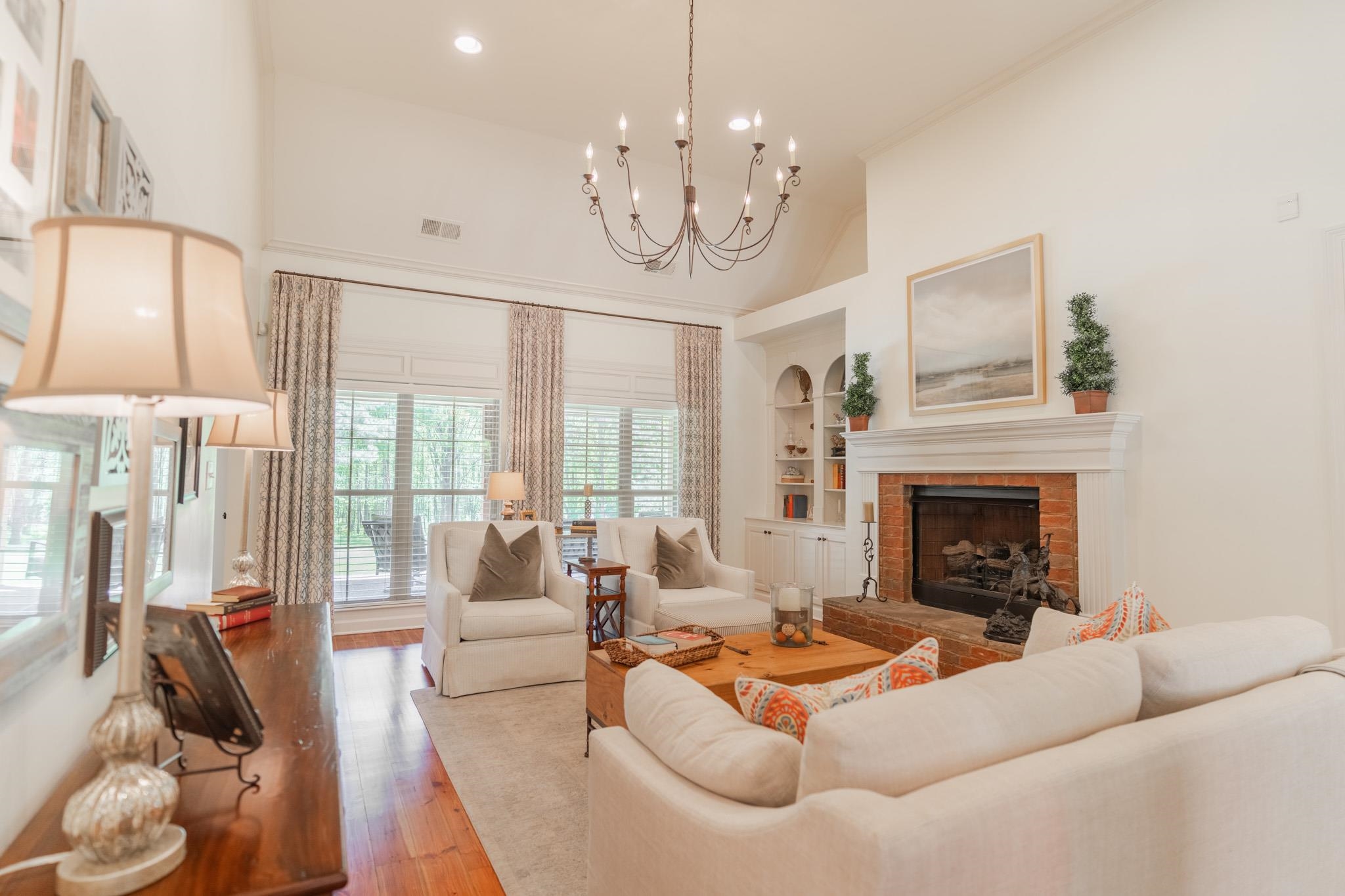 12035 Raleigh Lagrange Road East Eads, TN 38028 - Photo 9 of 37 Custom Built Ins, a beautiful chandelier, & fireplace add so much charm to this room! It leads to the kitchen area & on the other side leads to the Primary Suite.