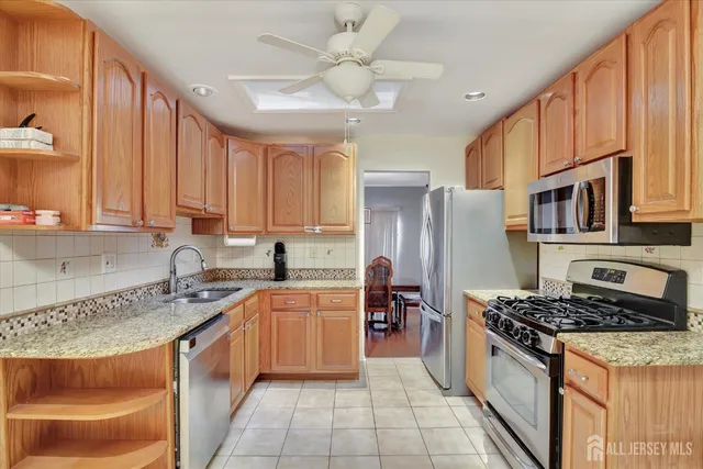 a kitchen with stainless steel appliances granite countertop a stove sink and cabinets