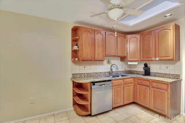 a kitchen with a sink cabinets and window