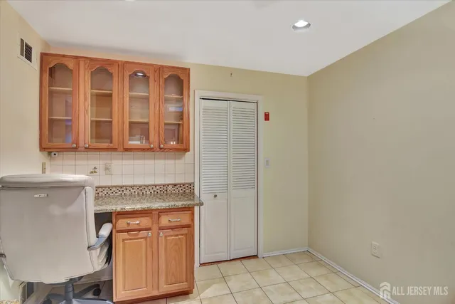 a spacious bathroom with a granite countertop sink a toilet and a bathtub