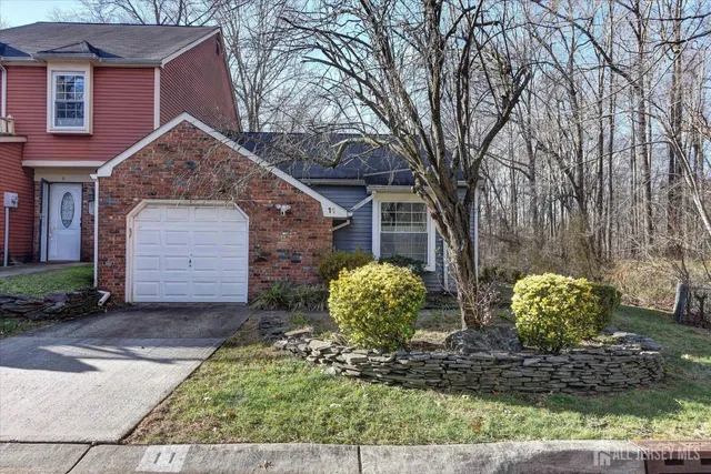 a view of a house with a yard and a tree