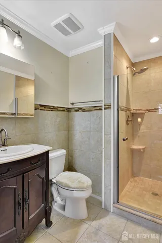 a bathroom with a toilet a sink and shower