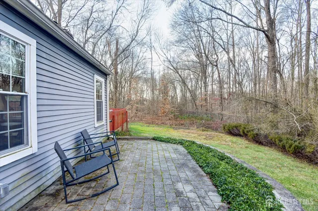 a backyard of a house with table and chairs