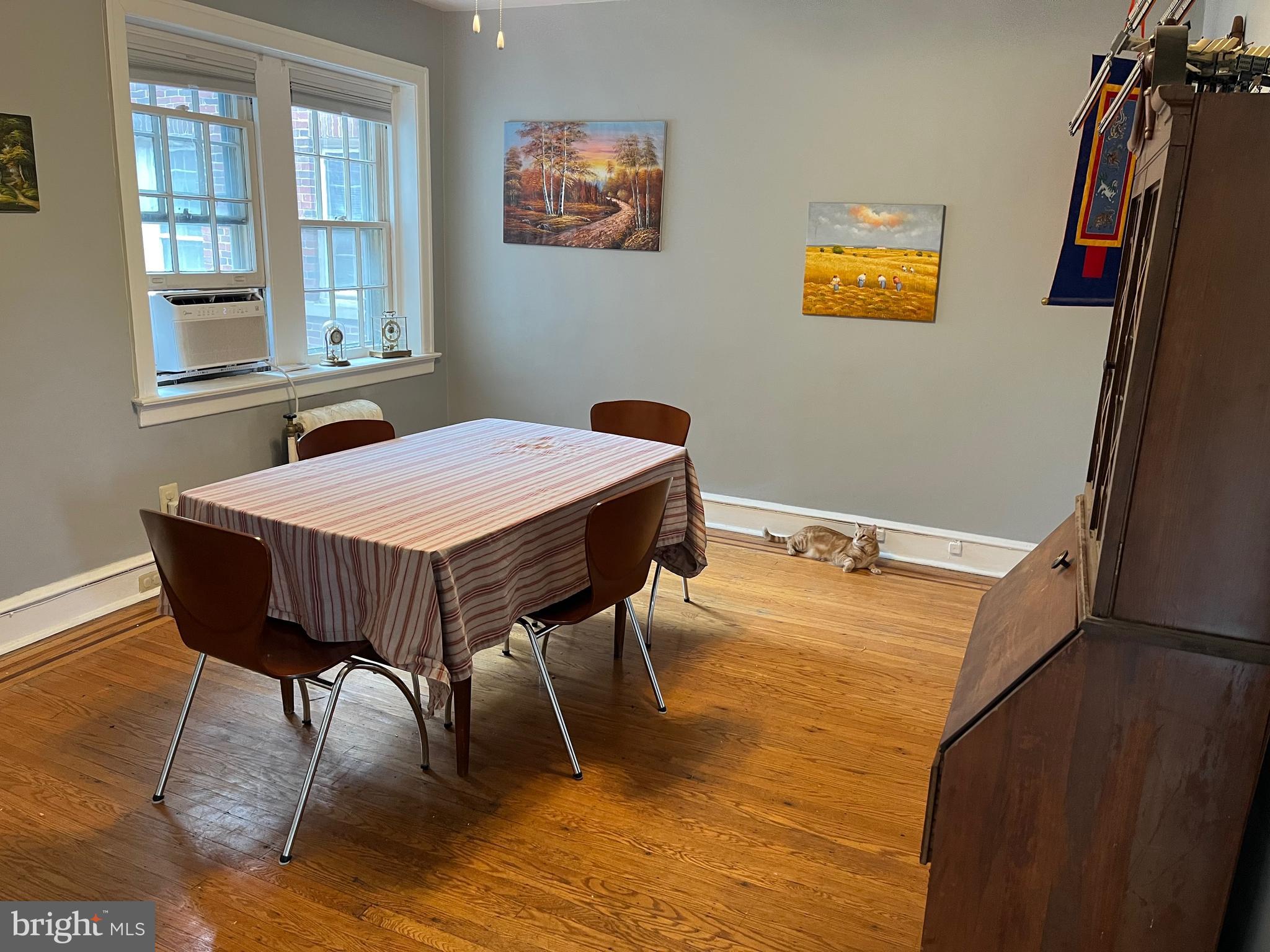 6146 Wayne Avenue, Unit 3 Philadelphia, PA 19144 - Photo 14 of 25 a dining room with a table chairs and a wooden floor
