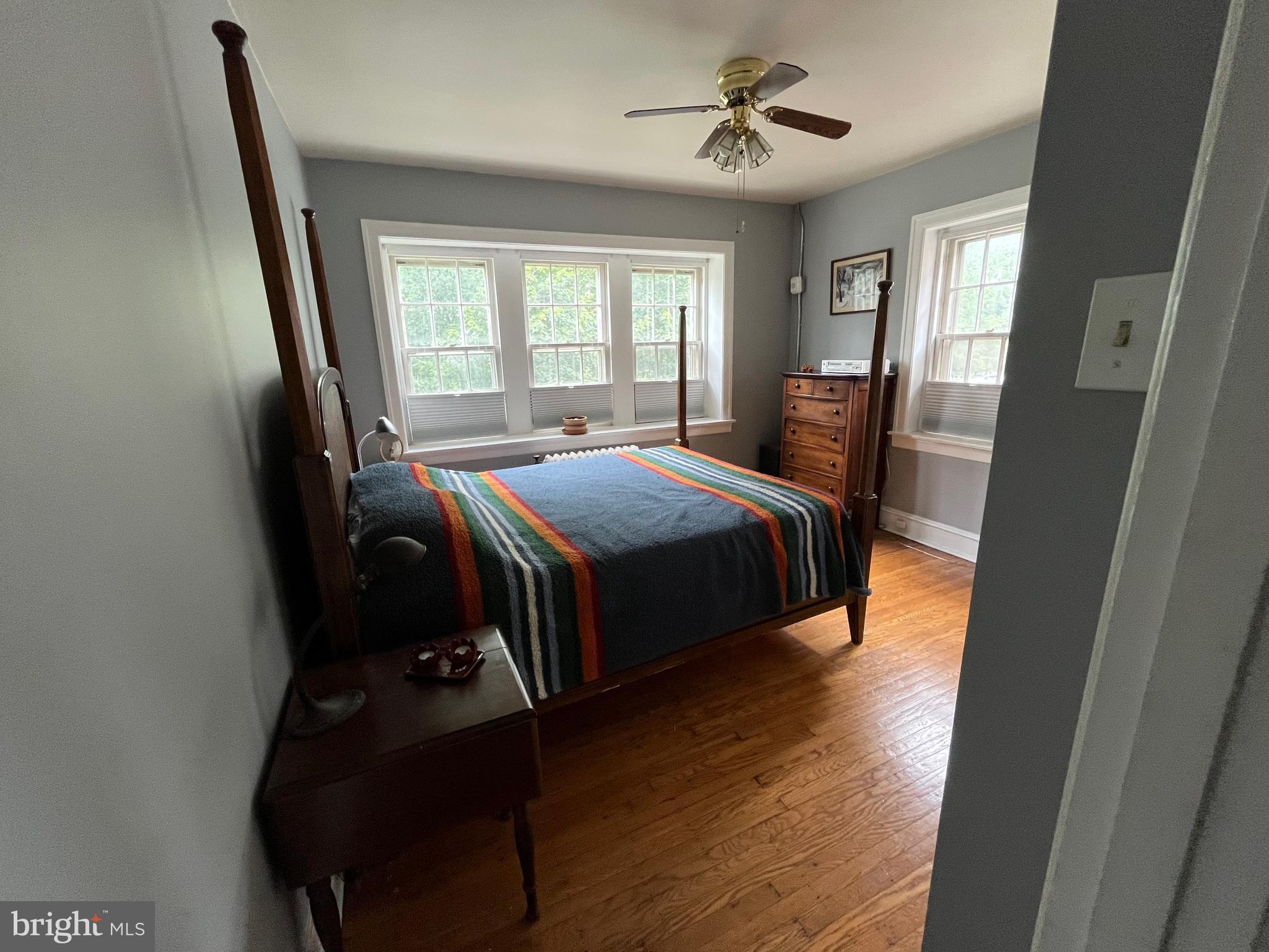 6146 Wayne Avenue, Unit 3 Philadelphia, PA 19144 - Photo 18 of 25 a bedroom with a bed and wooden floor