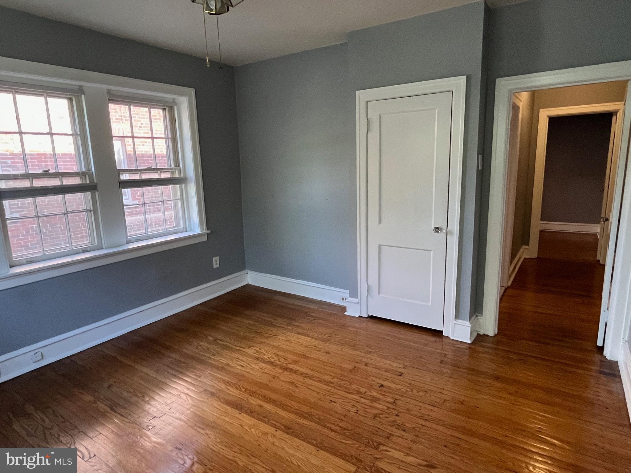 6146 Wayne Avenue, Unit 3 Philadelphia, PA 19144 - Photo 19 of 25 an empty room with wooden floor and windows