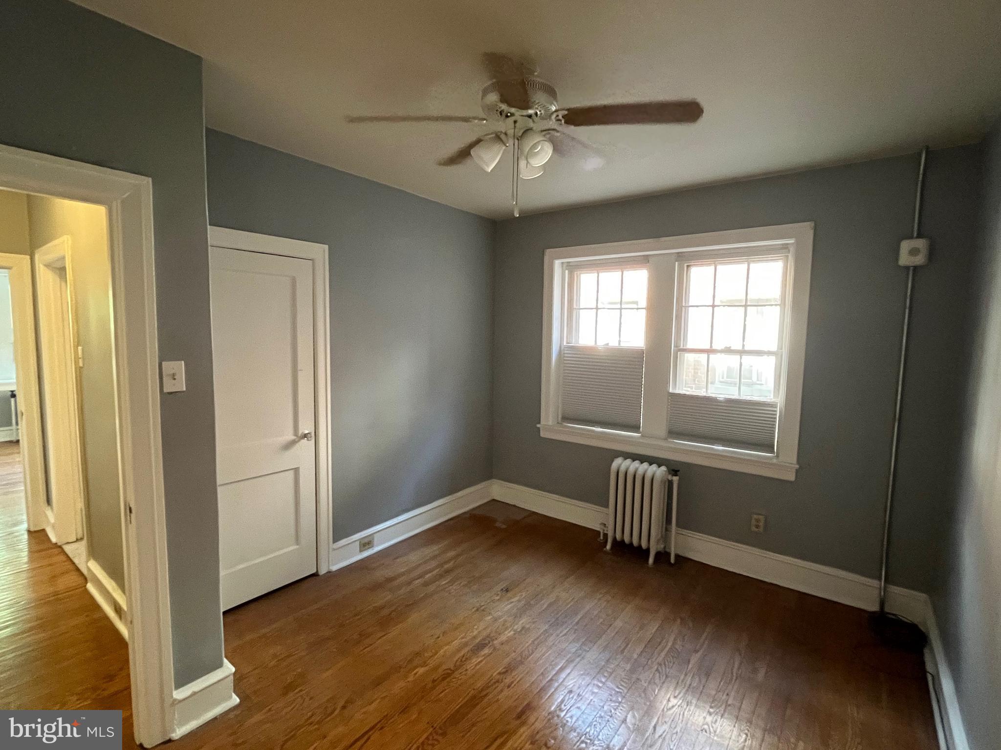 6146 Wayne Avenue, Unit 3 Philadelphia, PA 19144 - Photo 20 of 25 an empty room with wooden floor and windows