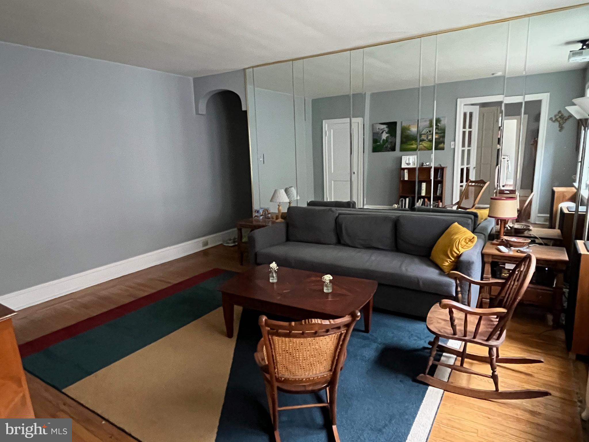 6146 Wayne Avenue, Unit 3 Philadelphia, PA 19144 - Photo 9 of 25 a living room with furniture and a wooden floor