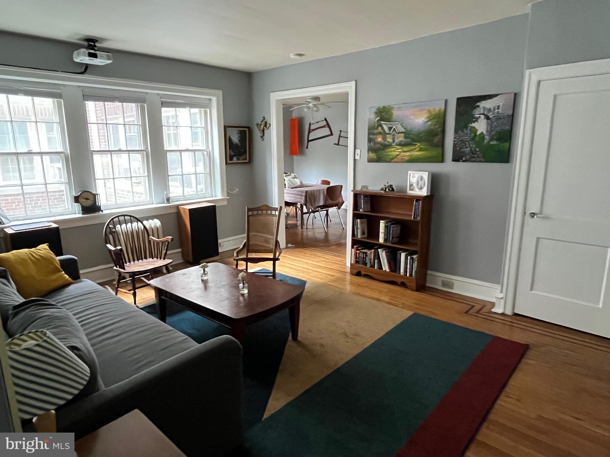 6146 Wayne Avenue, Unit 3 Philadelphia, PA 19144 - Photo 10 of 25 a living room with furniture and a wooden floor