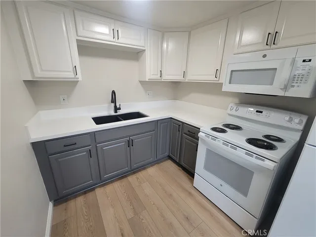 a kitchen with a sink stove and cabinets