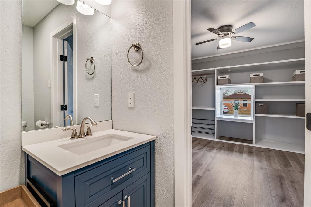 406 Freeman Street Mesquite, TX 75149 - Photo 14 of 22 a bathroom with a sink a vanity and a mirror