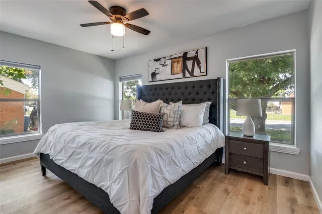 a bedroom with a bed and a large window