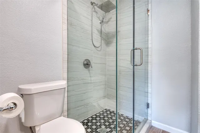 a bathroom with a toilet and shower