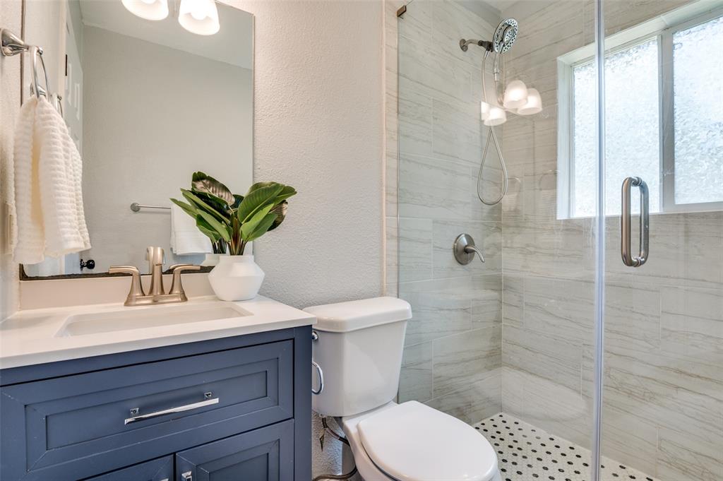 406 Freeman Street Mesquite, TX 75149 - Photo 19 of 22 a bathroom with a sink a toilet and shower