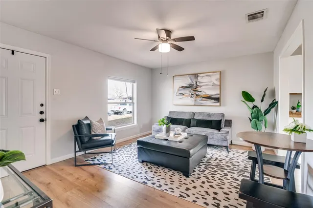 a living room with furniture and a potted plant