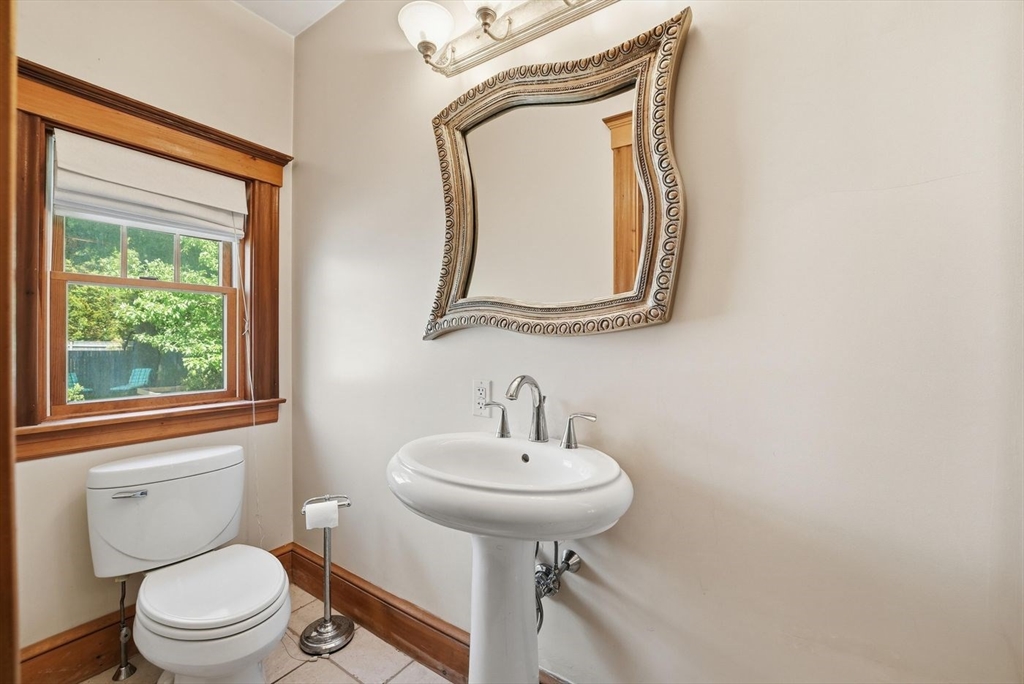 19 Humphrey Street Marblehead, MA 01945 - Photo 14 of 29 a bathroom with a toilet sink and mirror
