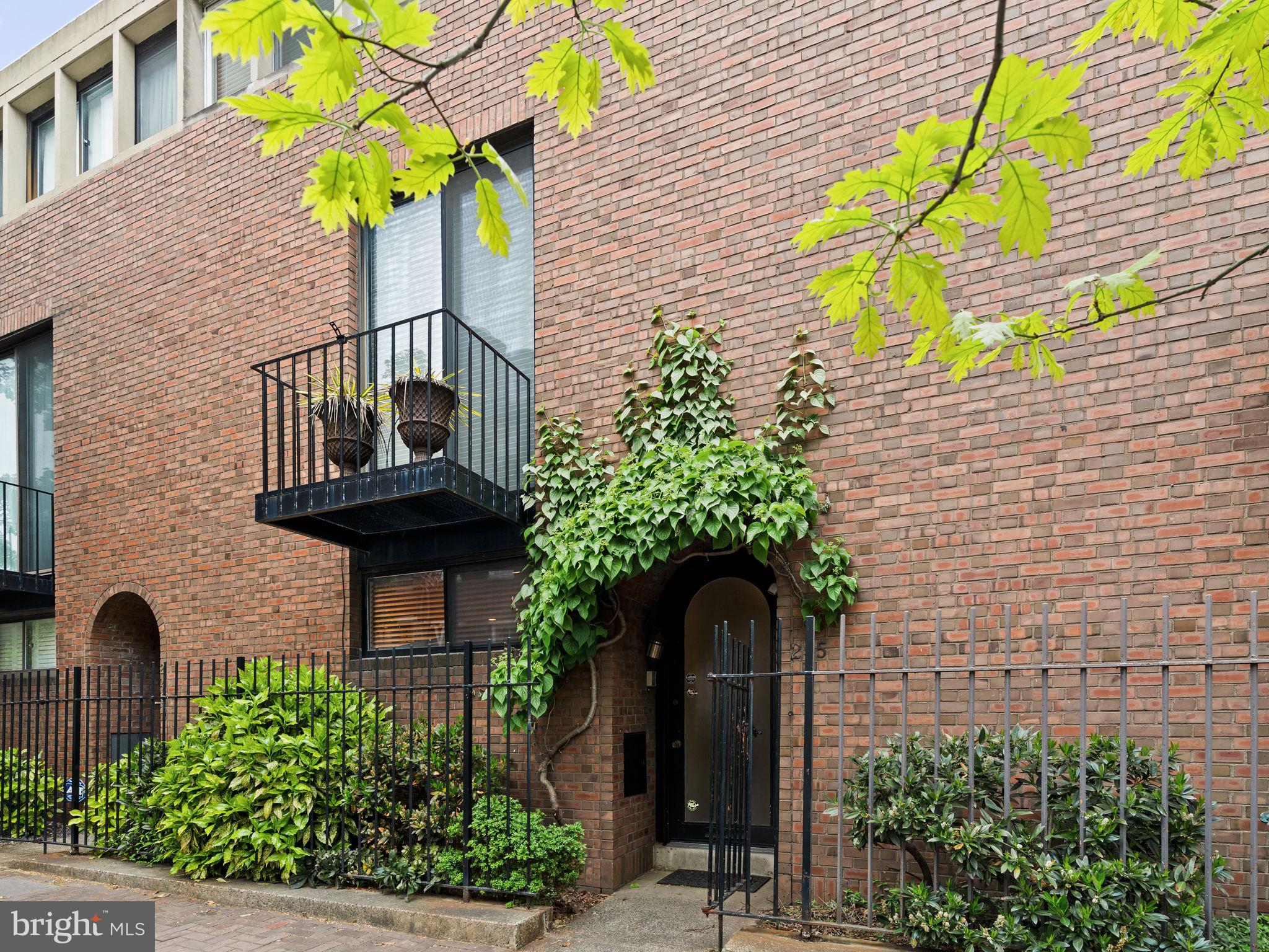 a front view of a house with plants