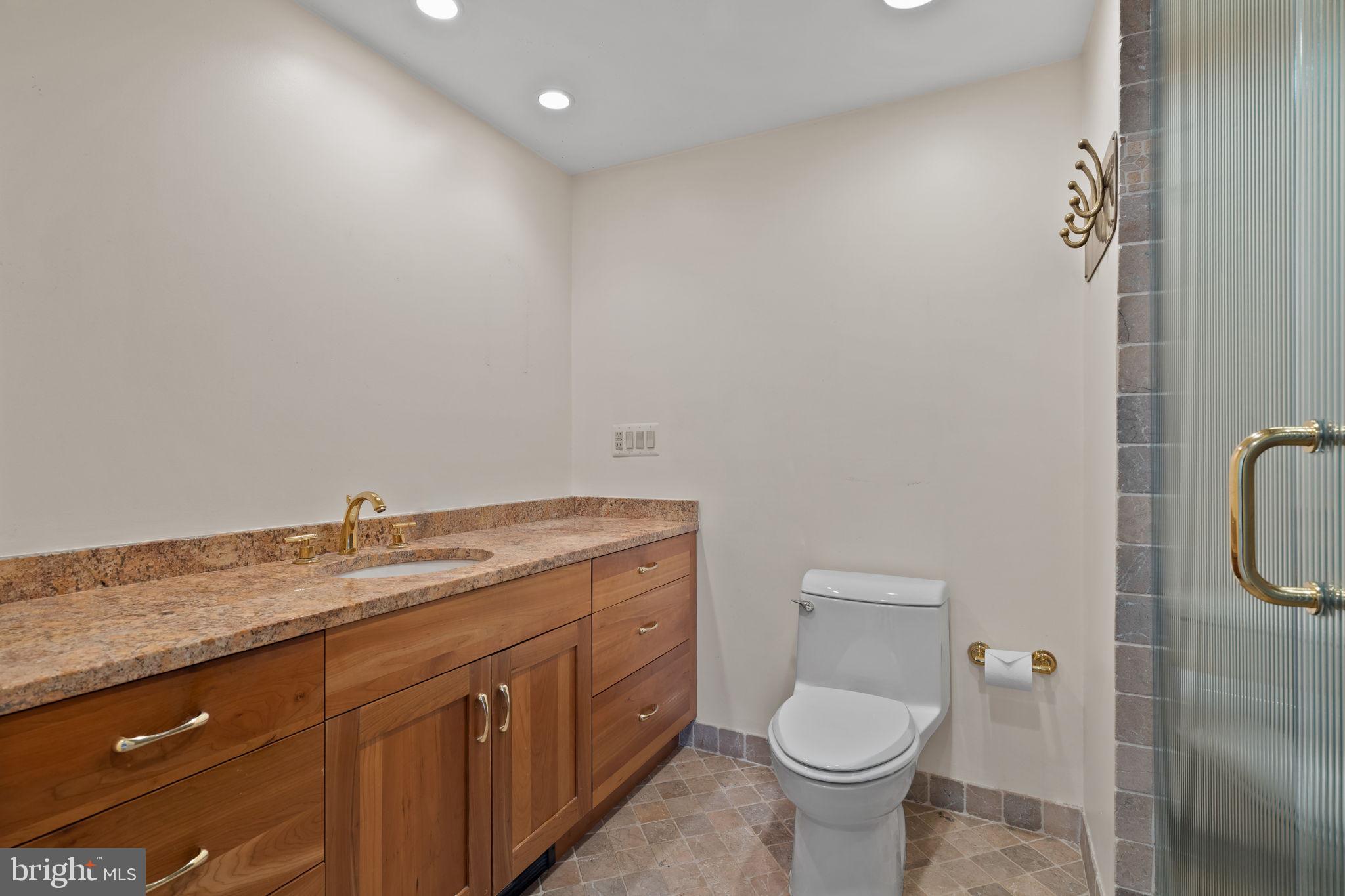 245 South 3rd Street Philadelphia, PA 19106 - Photo 38 of 63 a bathroom with a granite countertop toilet and a sink