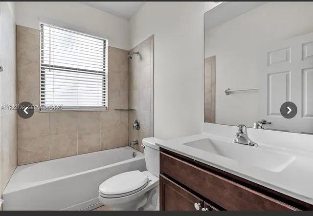 a bathroom with a sink a toilet tub and shower