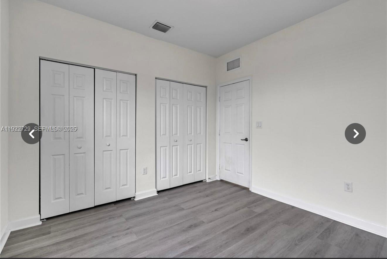 10091 West 35th Lane, Unit 10091 Hialeah, FL 33018 - Photo 23 of 32 a view of a livingroom with wooden floor