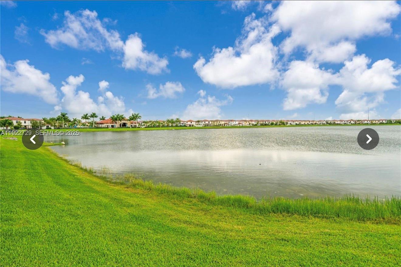 10091 West 35th Lane, Unit 10091 Hialeah, FL 33018 - Photo 31 of 32 a view of a lake with houses in the back