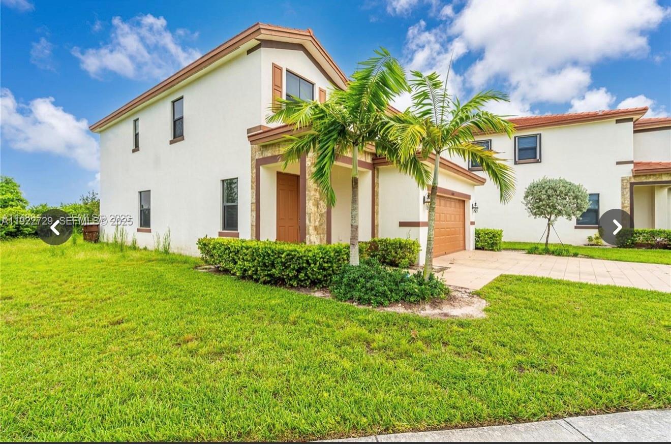 10091 West 35th Lane, Unit 10091 Hialeah, FL 33018 - Photo 32 of 32 a front view of a house with garden