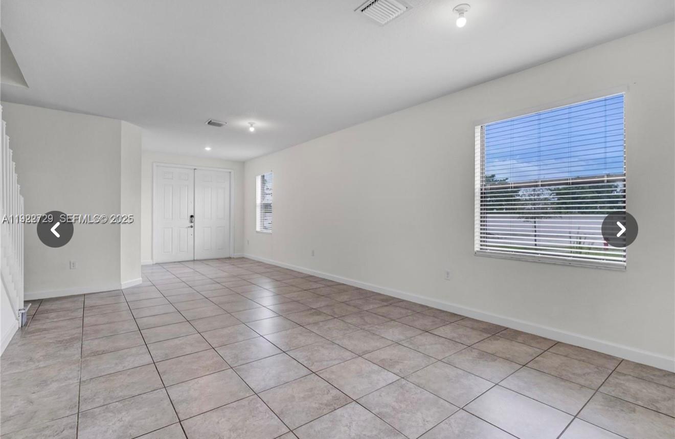 10091 West 35th Lane, Unit 10091 Hialeah, FL 33018 - Photo 6 of 32 a view of an empty room with a window