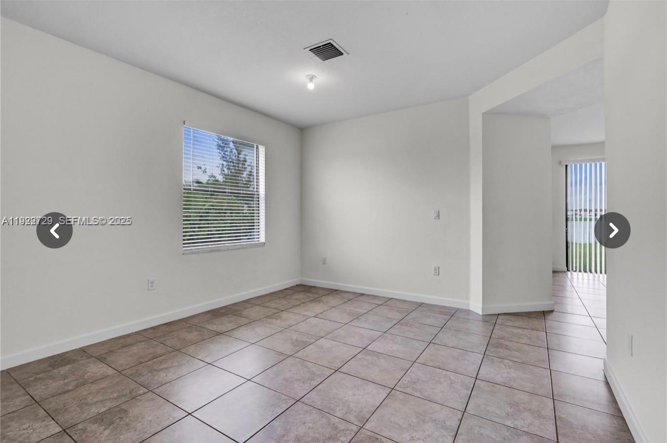 10091 West 35th Lane, Unit 10091 Hialeah, FL 33018 - Photo 8 of 32 a view of an empty room with a window