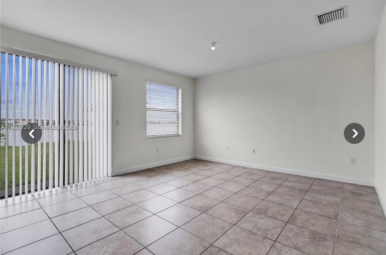 10091 West 35th Lane, Unit 10091 Hialeah, FL 33018 - Photo 10 of 32 an empty room with windows