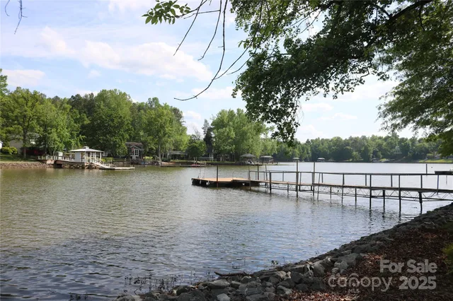 a view of a lake with boats and trees in the background