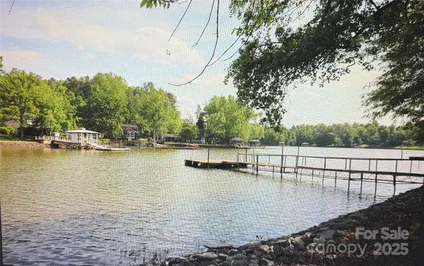 a view of a lake with boats and trees in the background