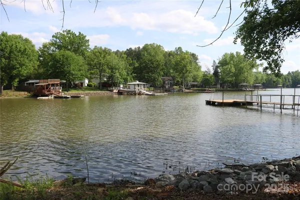 a view of a lake with boats and trees in the background