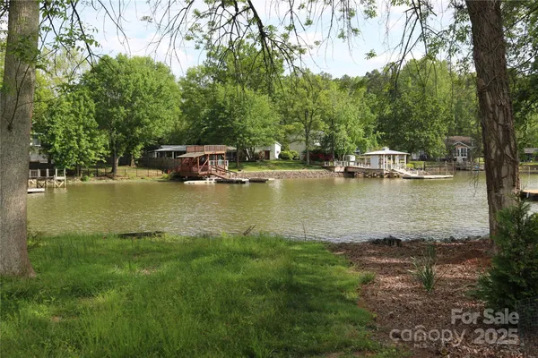 a view of a lake with houses in the back