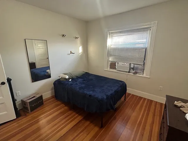 a bedroom with a bed and a mirror