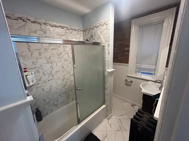 a bathroom with a shower and a sink