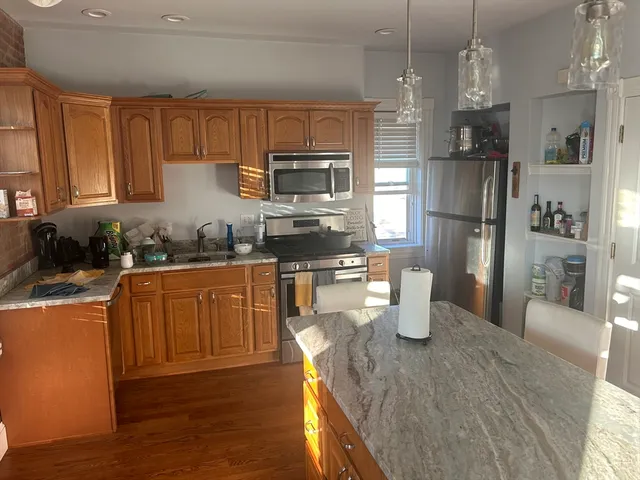 a kitchen with a refrigerator a stove top oven a sink and dishwasher