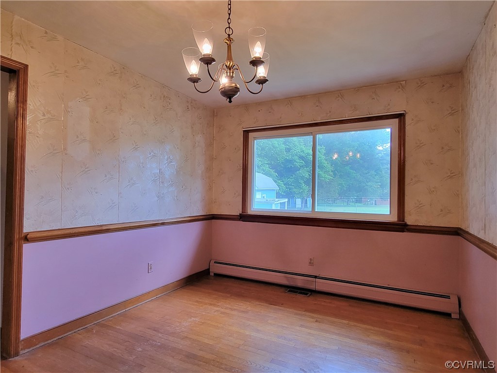 7529 Wilton Road Henrico, VA 23231 - Photo 15 of 31 a view of an empty room with wooden floor and a window