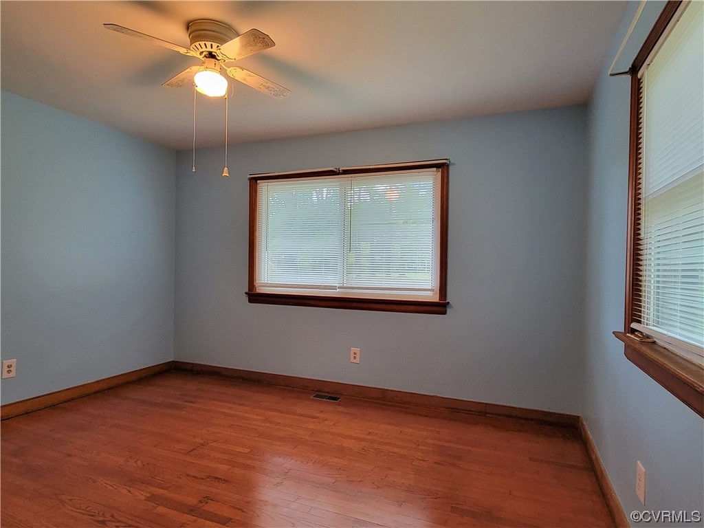 7529 Wilton Road Henrico, VA 23231 - Photo 21 of 31 an empty room with wooden floor chandelier fan and windows