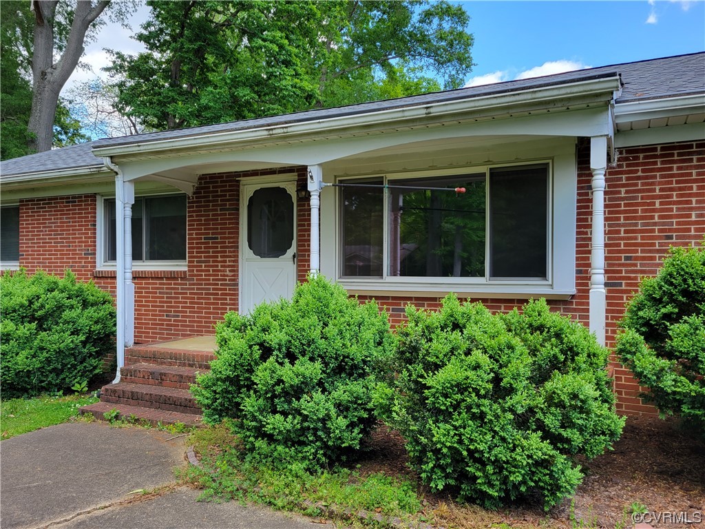 7529 Wilton Road Henrico, VA 23231 - Photo 24 of 31 a view of a house with potted plants and a large tree