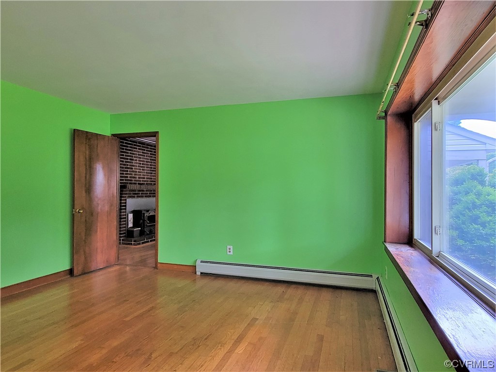 7529 Wilton Road Henrico, VA 23231 - Photo 4 of 31 an empty room with wooden floor and windows