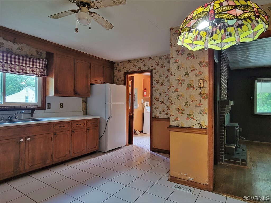 7529 Wilton Road Henrico, VA 23231 - Photo 9 of 31 a kitchen with stainless steel appliances granite countertop a sink a stove a refrigerator a dining table and chairs with wooden floor