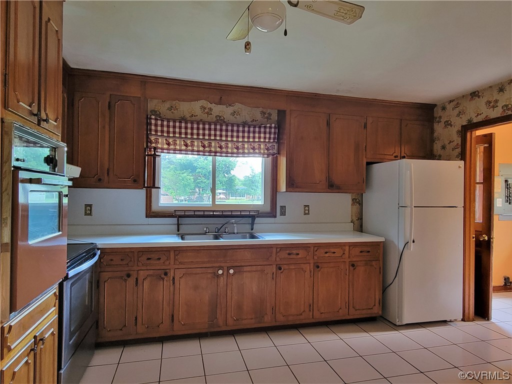7529 Wilton Road Henrico, VA 23231 - Photo 10 of 31 a kitchen with a sink a refrigerator and a window