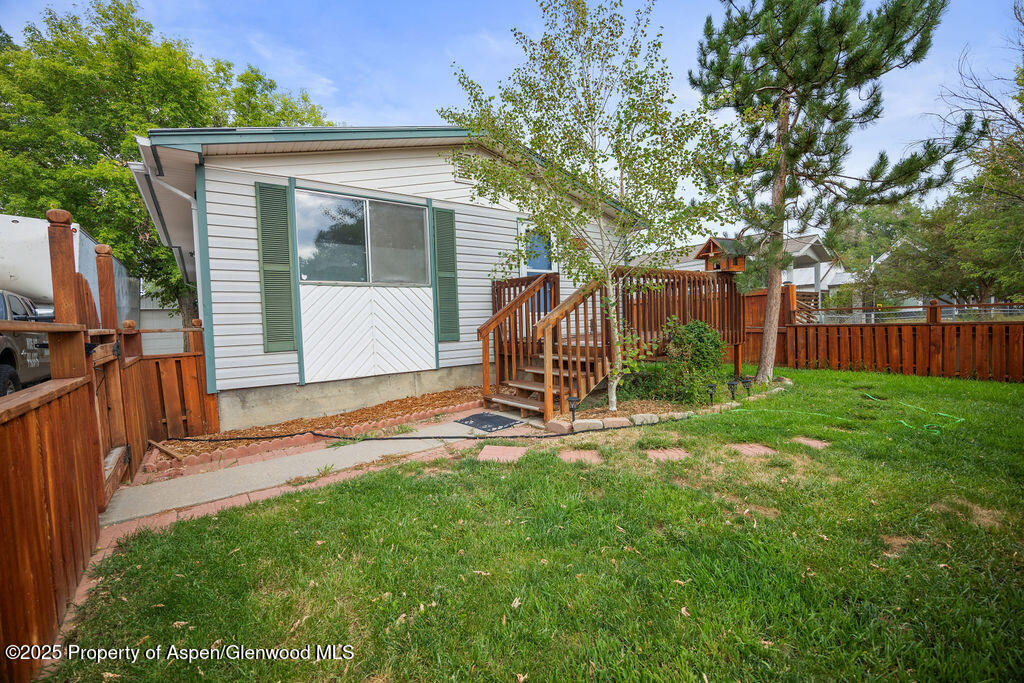 562 Rose Street Craig, CO 81625 - Photo 12 of 59 a backyard of a house with barbeque oven table and chairs