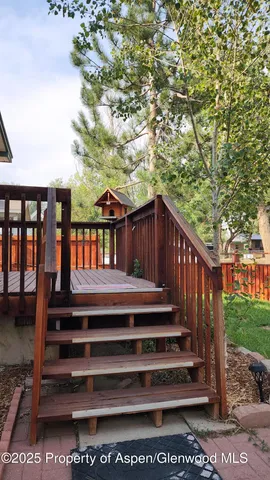 a view of a wooden deck front of house