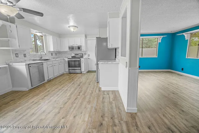 a spacious bathroom with a sink a large mirror and a window