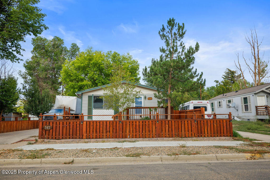 562 Rose Street Craig, CO 81625 - Photo 2 of 59 a view of a house with a small yard and wooden fence