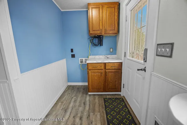 a view of a room with wooden floor and a window