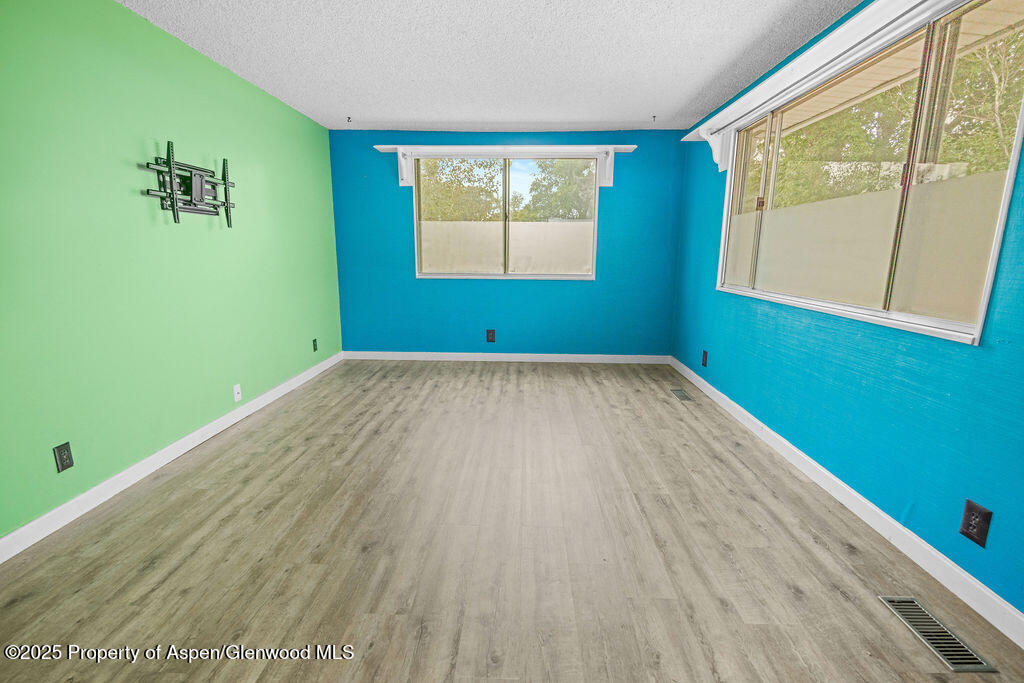 562 Rose Street Craig, CO 81625 - Photo 24 of 59 a view of an empty room with a window and wooden floor