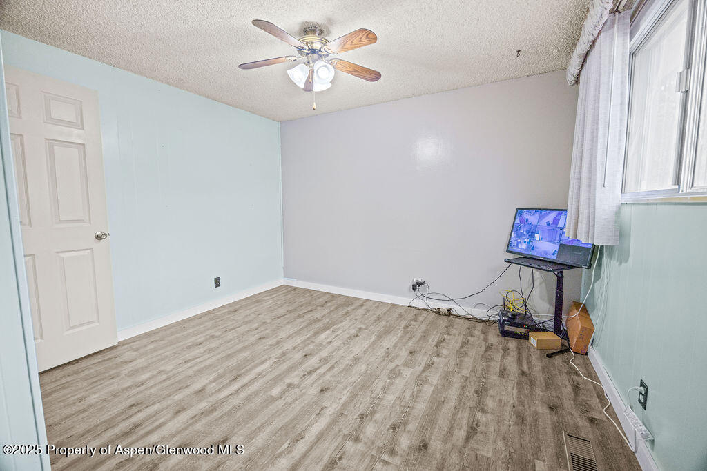 562 Rose Street Craig, CO 81625 - Photo 28 of 59 a view of a room with a ceiling fan and wooden floor